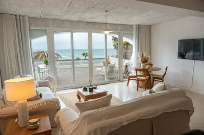 a living room with a view of the ocean at Apartamento Mare Aveiros Beach in Albufeira