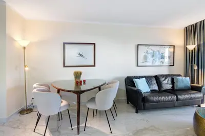 a living room with a table and a couch at Celestial Blue Vale Do Lobo in Almancil