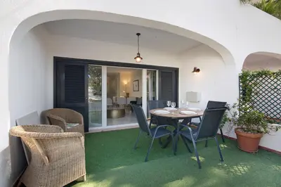 an outdoor patio with a table and chairs at Celestial Blue Vale Do Lobo in Almancil