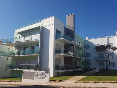 a white building with balconies on the side of it at Modern apartment on the beach of Falesia in Albufeira