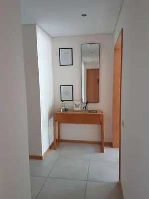 a bathroom with a wooden vanity and a mirror at Modern apartment on the beach of Falesia in Albufeira