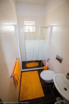 a bathroom with a shower and a toilet and a sink at Villa Azul in Boliqueime