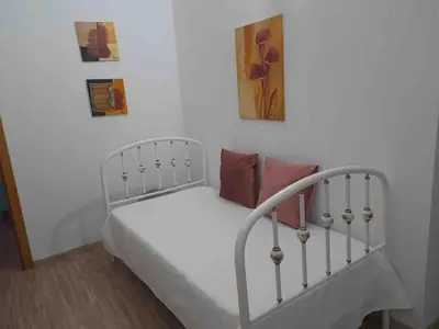 a bedroom with a white bed with pillows on it at Villa Azul in Boliqueime