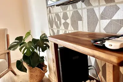 a potted plant sitting next to a wooden table at Stunning beach apartment in Almancil