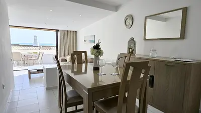 a kitchen and dining room with a table and chairs at Albufeira, Blue Wave Retreat 65 in Albufeira