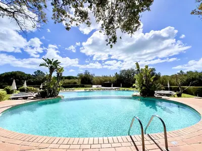 a large swimming pool with blue water at Albufeira Balaia Golf Vilage 7 With Pool by Homing in Albufeira