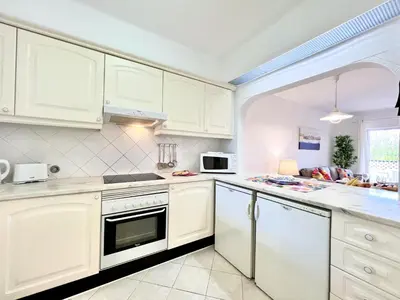 a kitchen with white cabinets and a stove top oven at Albufeira Balaia Golf Vilage 7 With Pool by Homing in Albufeira