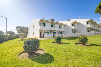 a large white building with bushes in the yard at Nature Escape 2BR Villa Pool Wi-Fi AC in Olhos de Água