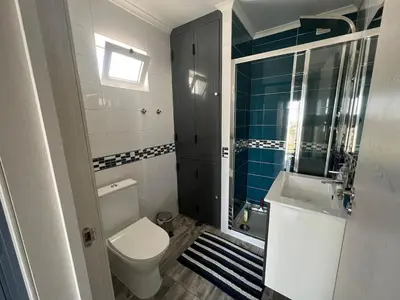a bathroom with a toilet and a sink at Casa rooftop jacuzzi and magnificent sea view in Albufeira