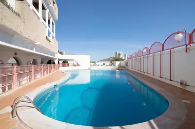 a swimming pool on the side of a building at Jungle Flat with Pool T2 Montechoro in Albufeira