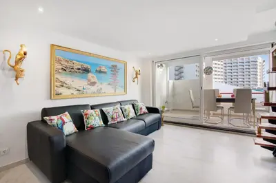 a living room with a couch and a table at Jungle Flat with Pool T2 Montechoro in Albufeira