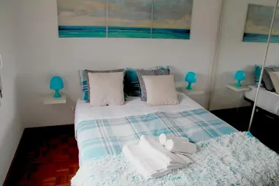 a bedroom with two beds and a couch at Brigida's Flat in Faro