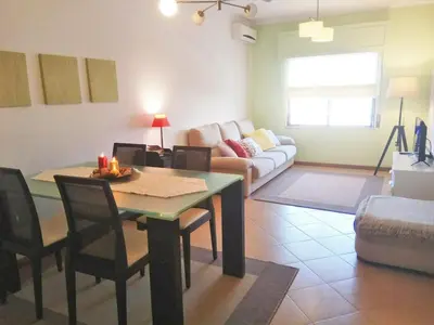 a living room with a table and a couch at Brigida's Flat in Faro