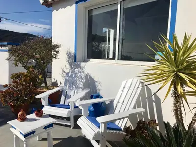 a wooden ladder in the sand next to a pool at Casa da Aldeia in Santa Bárbara de Nexe