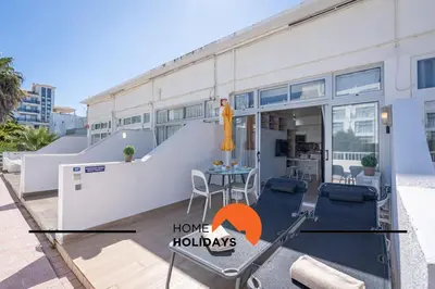 a house with a balcony with a table and chairs at #255 Oura Cilla by Home Holidays in Albufeira