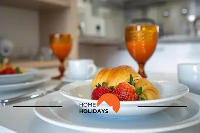 a plate of strawberries and croissants on a table at #255 Oura Cilla by Home Holidays in Albufeira