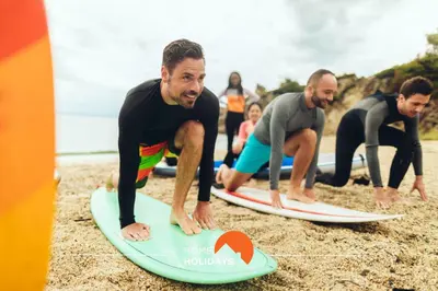 a group of men on surfboards on the beach at #255 Oura Cilla by Home Holidays in Albufeira