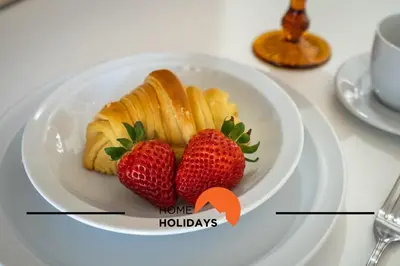 a plate with strawberries and croissants on a table at #255 Oura Cilla by Home Holidays in Albufeira