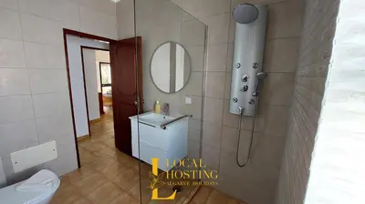 a bathroom with a toilet and a sink and a mirror at Golden Algarve Apartament By Localhosting in Albufeira