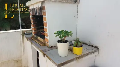 two potted plants sitting on a window sill at Golden Algarve Apartament By Localhosting in Albufeira
