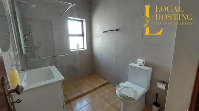 a bathroom with a white toilet and a sink at Golden Algarve Apartament By Localhosting in Albufeira