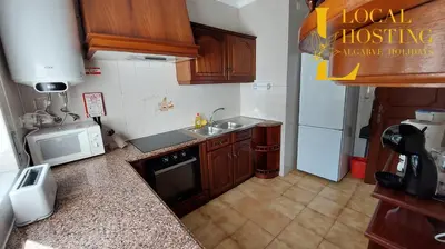 a small kitchen with a sink and a stove at Golden Algarve Apartament By Localhosting in Albufeira