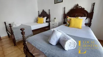 a bedroom with two beds with yellow and white pillows at Golden Algarve Apartament By Localhosting in Albufeira