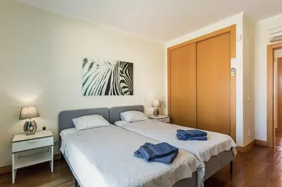 a bedroom with a bed with two towels on it at Casa Peva in Albufeira