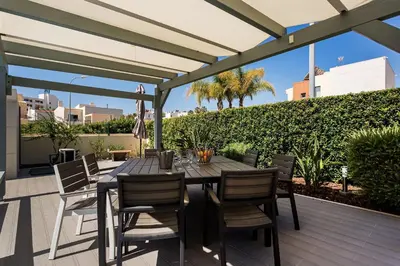 a wooden table and chairs on a wooden deck at Casa Peva in Albufeira