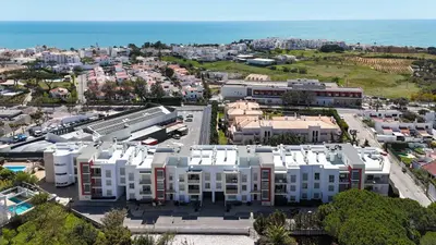 an aerial view of a city with buildings and the ocean at Medronheira - Apt 1A by HelloVacations in Albufeira