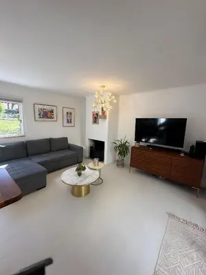 a living room with a couch and a flat screen tv at Vilamoura Modern House in Quarteira