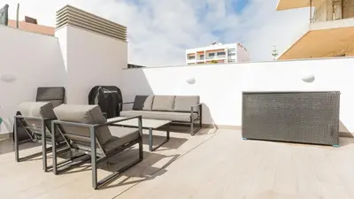 a patio with chairs and a table on a building at Orange Boutique Residence - Casa Farol Adults Only in Quarteira