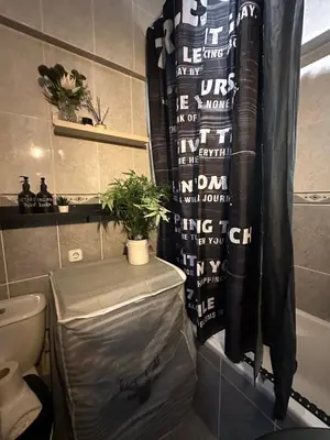 a bathroom with a toilet and a shower curtain at Beach Holidays in Quarteira