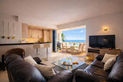 a living room with a leather couch and a television at Ocean Bliss - Panoramic Sea View - 20m to Beach - 2 Swimming Pools - Private Parking in Albufeira