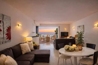 a living room with a couch and a table at Ocean Bliss - Panoramic Sea View - 20m to Beach - 2 Swimming Pools - Private Parking in Albufeira