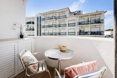 a room with a white cabinet and a bed at Central Condo-Pool by Algarve Dream Holidays in Albufeira