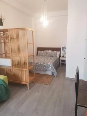 a bedroom with a bed and a wooden floor at House e Beach in Albufeira