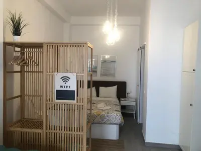 a small bedroom with a bed and a wooden crib at House e Beach in Albufeira