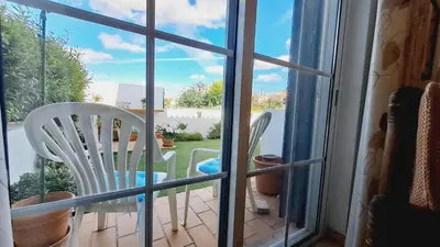 a view of a table and chairs from a window at Albufeira Home Paderne in Paderne