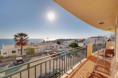 a balcony with a view of a city and the ocean at Hofnar Sea View Apartment in Albufeira