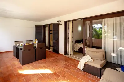 a living room with a couch and a chair at Apartamento Laurus in Albufeira