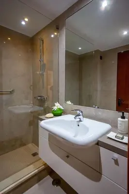 a bathroom with a sink and a shower and a mirror at Apartamento Laurus in Albufeira