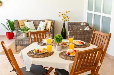 a table with plates of food and orange juice at Apartment Curitiba by Algarve Vacation in Albufeira