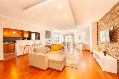 a living room with a couch and a stone wall at Apartment Curitiba by Algarve Vacation in Albufeira
