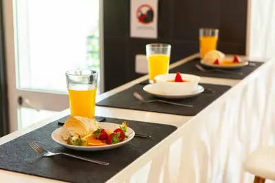 a table with two plates of food and two glasses of orange juice at Apartment Curitiba by Algarve Vacation in Albufeira
