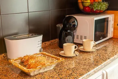 a kitchen counter with a toaster and a basket of food at Apartment Curitiba by Algarve Vacation in Albufeira