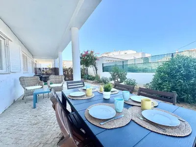 a blue table with plates on it on a patio at Beach 15 min away! - Rustic with AC and WiFi in Quarteira