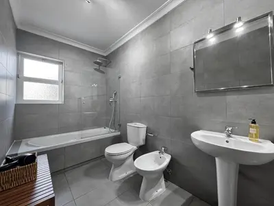 a bathroom with a toilet and a sink and a tub at Beach 15 min away! - Rustic with AC and WiFi in Quarteira