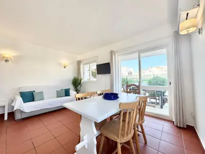 a living room with a table and chairs and a couch at Beach 15 min away! - Rustic with AC and WiFi in Quarteira