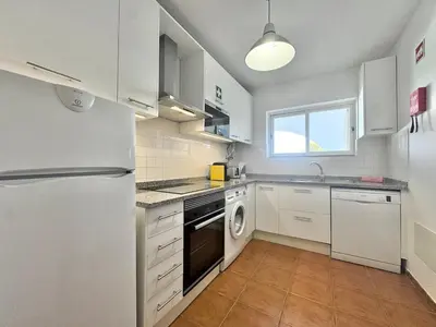 a kitchen with a white refrigerator and a dishwasher at Beach 15 min away! - Rustic with AC and WiFi in Quarteira
